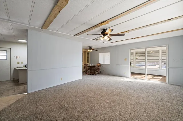 a view of a livingroom with a furniture and a ceiling fan