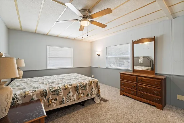 a bedroom with a bed dresser and a window