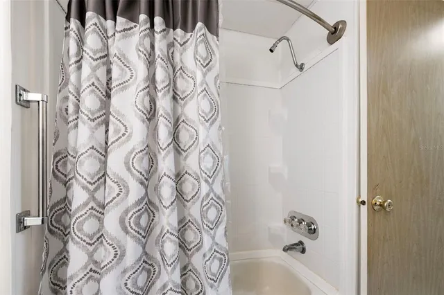 a bathroom with a bathtub and shower curtain