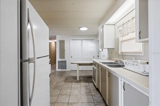 a kitchen with a sink stove and refrigerator