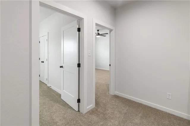 a view of empty room with ceiling fan