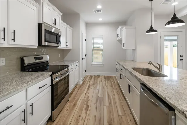 a view of a livingroom with a furniture wooden floor and a ceiling fan