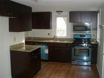 137 Baxter Road Hyannis, MA 02601 - Photo 3 of 9 a kitchen with a sink stove and microwave