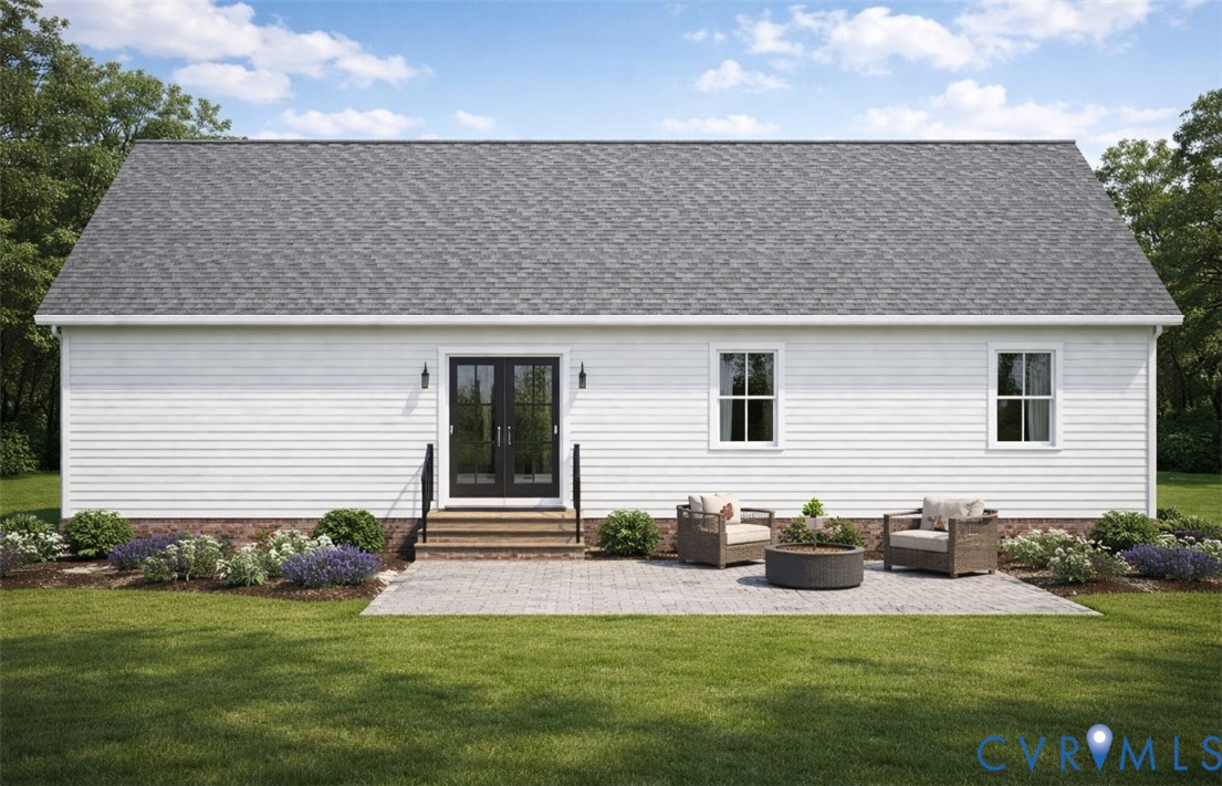 Back of property with a lawn, a patio area, an out