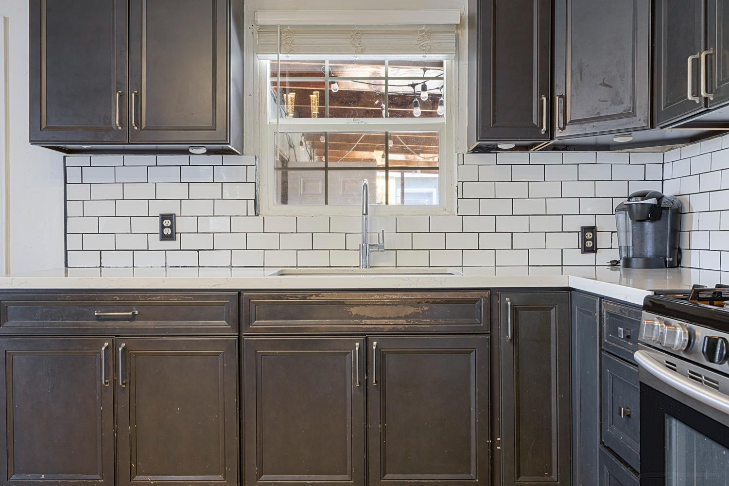 1030 Alpha Road Turlock, CA 95380 - Photo 12 of 25 a kitchen with stainless steel appliances wooden cabinets and a sink