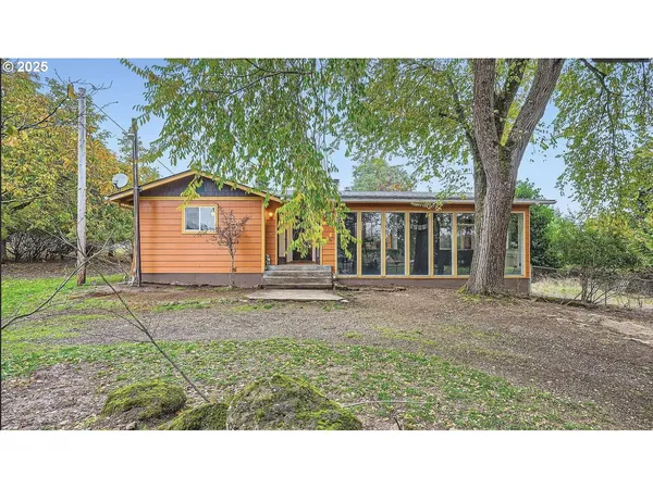 a backyard of a house with a yard and trampoline