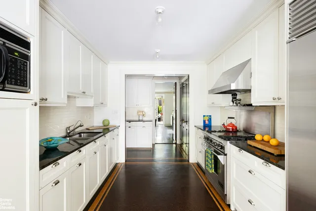 a workspace with furniture and a large window