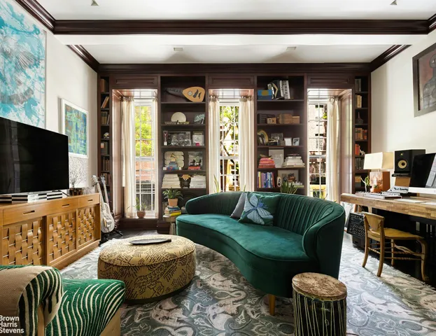 a living room with furniture or couch and a chandelier