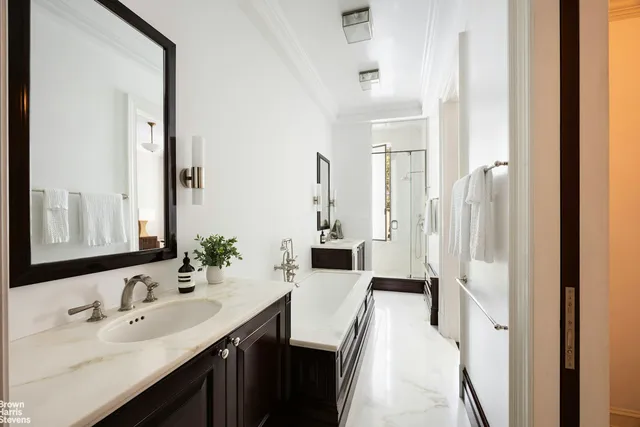 a living room with furniture a fireplace and a large window