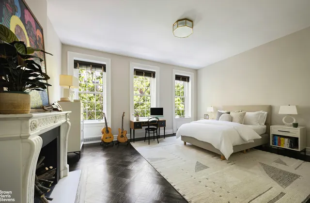 a bedroom with a bed and a fireplace