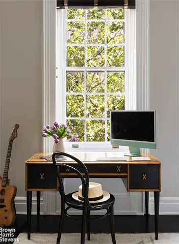 a spacious bedroom with a bed and a chandelier
