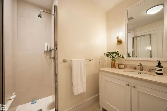 a bedroom with a bed and large windows