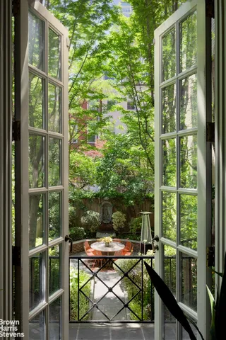 a living room with furniture and floor to ceiling windows