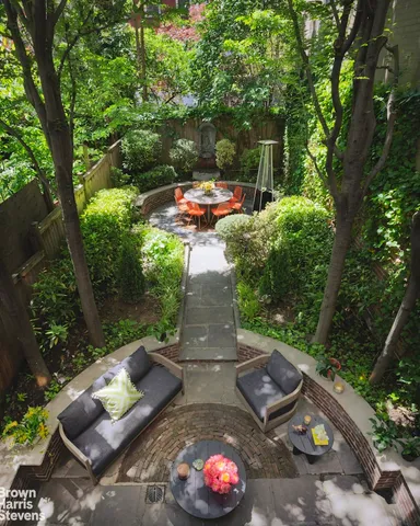 a view of a balcony with chairs and wooden fence