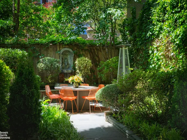 a view of a patio with couches table and chairs and potted plants