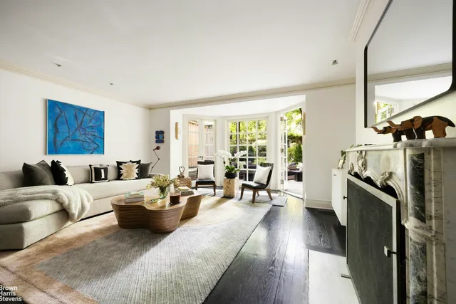 a backyard of a house with a yard and outdoor seating