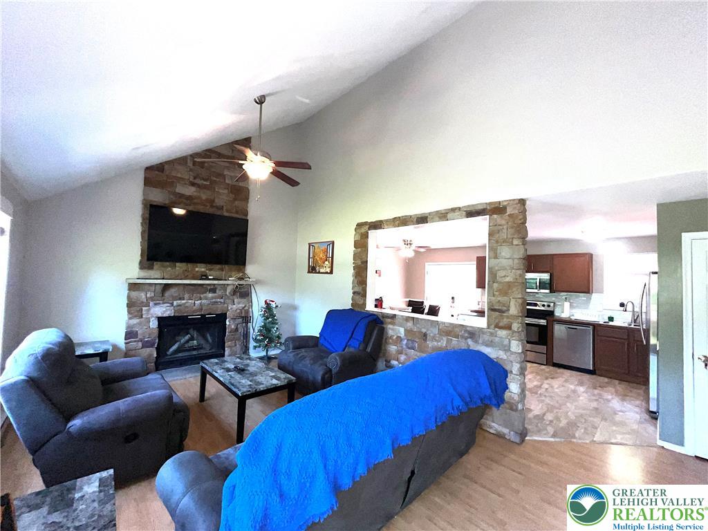 1646 Clover Road Long Pond, PA 18334 - Photo 4 of 24 Vaulted ceilings and a stone fireplace define this inviting, open living space.