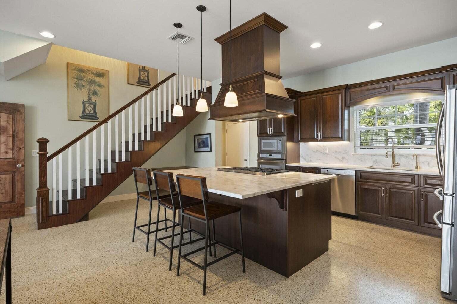 1009 Northwest Terrace Road Stuart, FL 34994 - Photo 14 of 69 a kitchen with stainless steel appliances granite countertop a stove a sink and a refrigerator