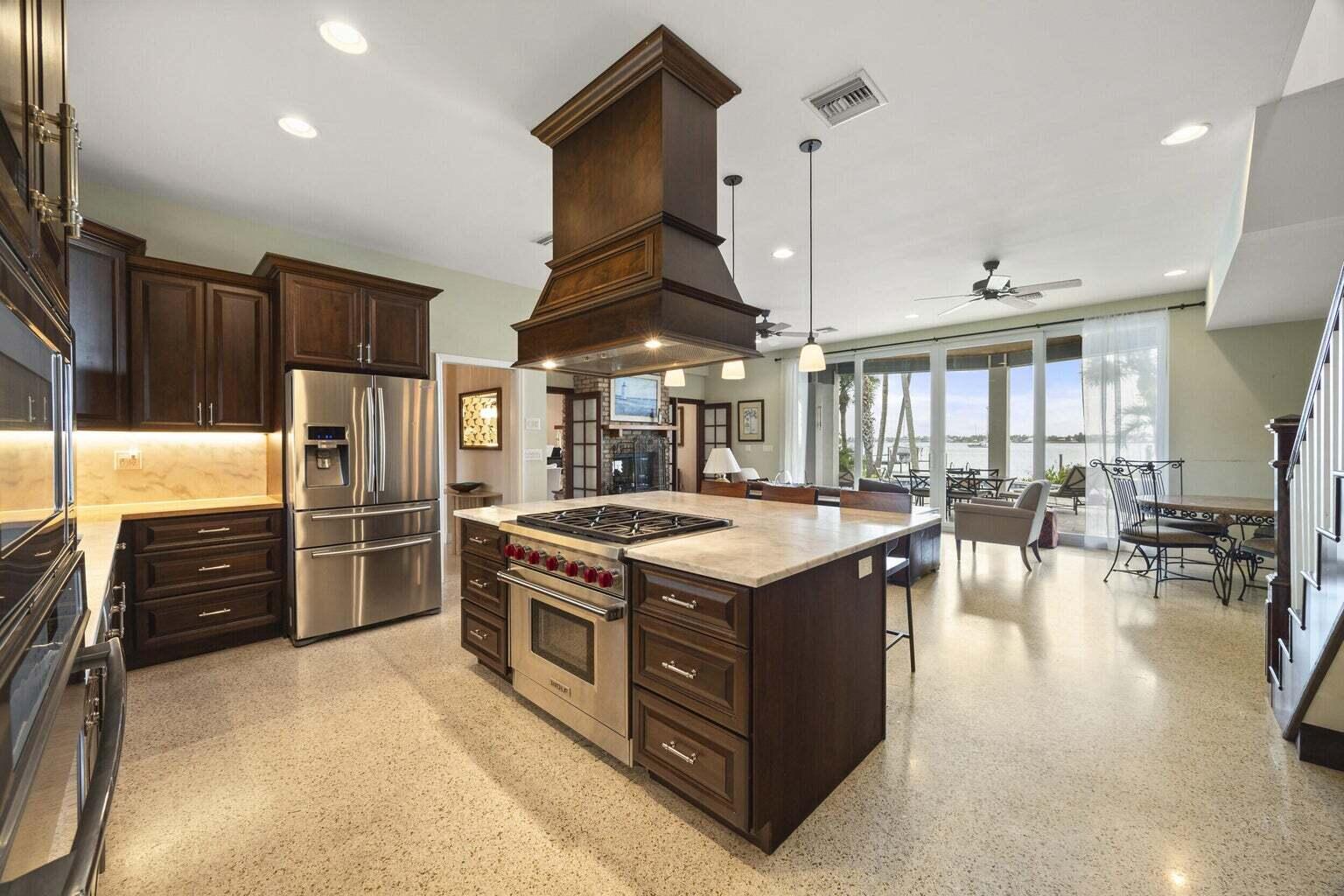 1009 Northwest Terrace Road Stuart, FL 34994 - Photo 16 of 69 a kitchen with stainless steel appliances granite countertop a stove and a refrigerator