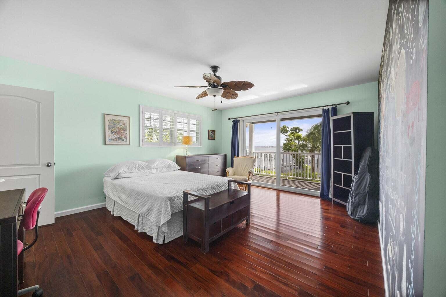 1009 Northwest Terrace Road Stuart, FL 34994 - Photo 34 of 69 a spacious bedroom with a bed and a large window