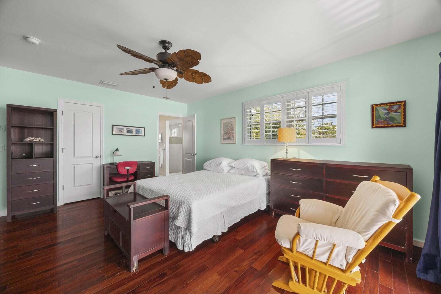 1009 Northwest Terrace Road Stuart, FL 34994 - Photo 35 of 69 a bedroom with a bed and wooden floor