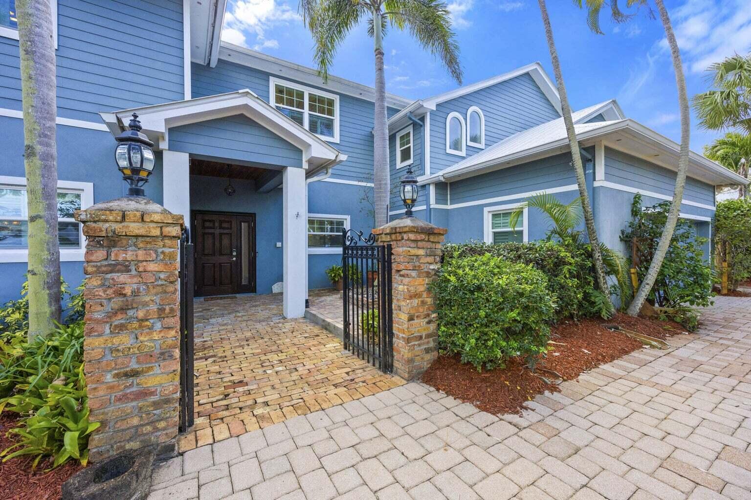 1009 Northwest Terrace Road Stuart, FL 34994 - Photo 4 of 69 a front view of a house with a yard