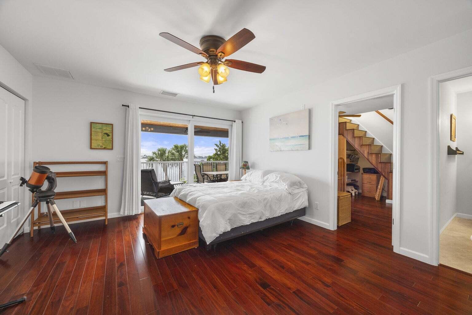 1009 Northwest Terrace Road Stuart, FL 34994 - Photo 42 of 69 a bedroom with a bed and wooden floor