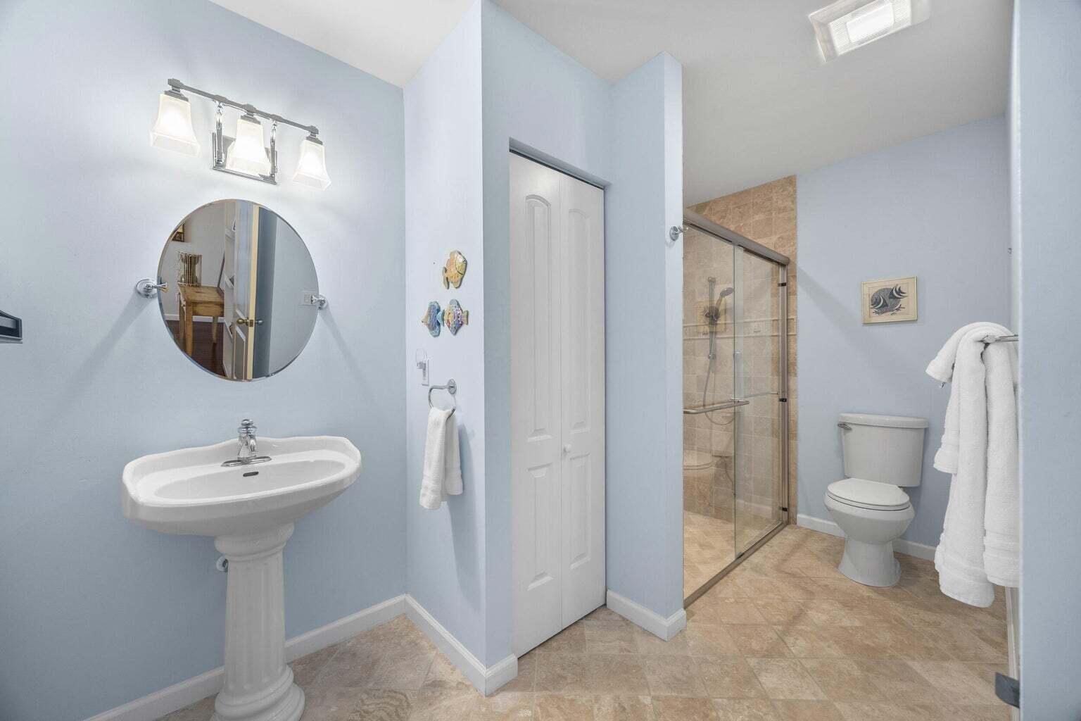 1009 Northwest Terrace Road Stuart, FL 34994 - Photo 46 of 69 a bathroom with a toilet sink and shower