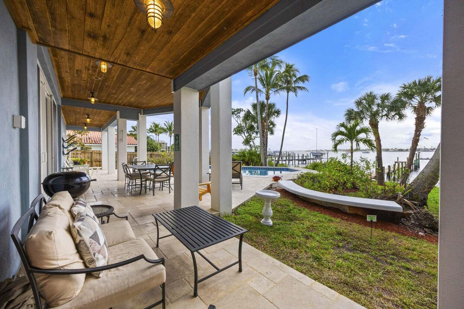 1009 Northwest Terrace Road Stuart, FL 34994 - Photo 56 of 69 a view of swimming pool with outdoor seating and plants