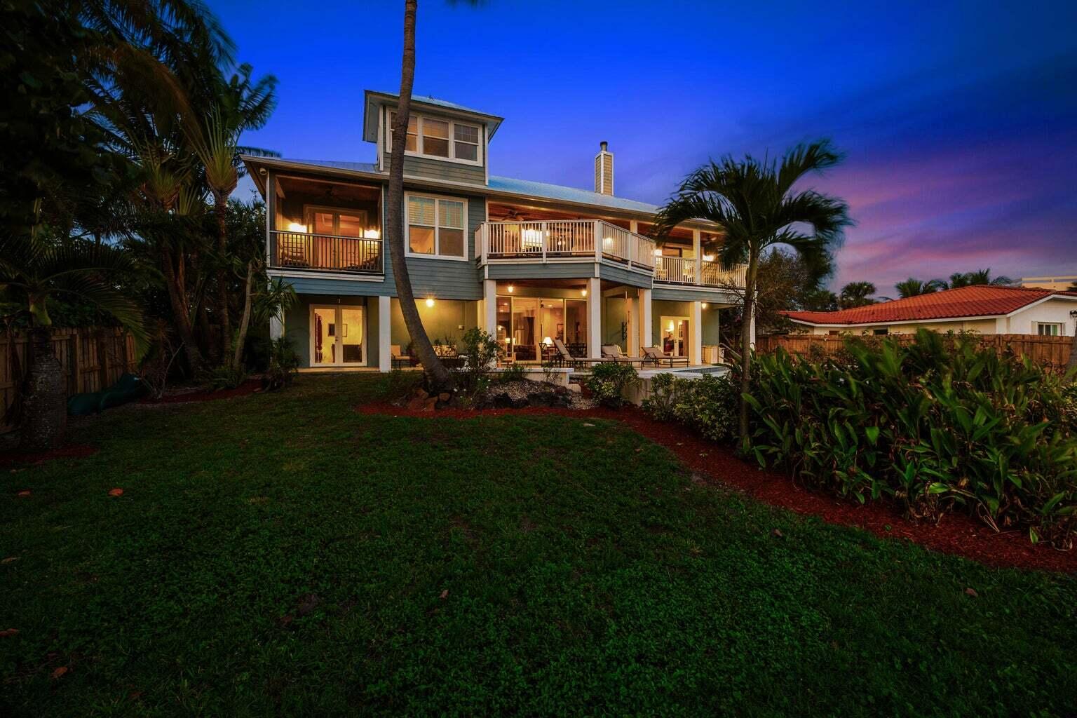 1009 Northwest Terrace Road Stuart, FL 34994 - Photo 61 of 69 a front view of a house with a yard table and chairs