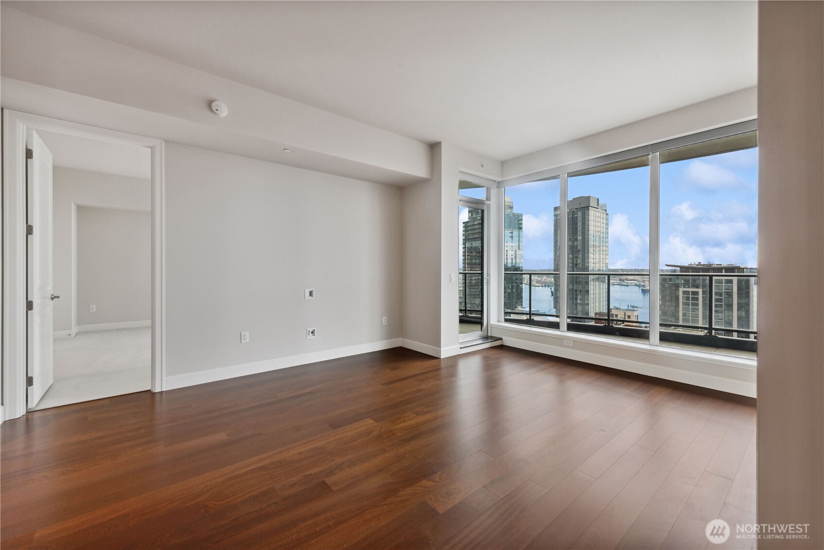 1920 4th Avenue, Unit 2702 Seattle, WA 98101 - Photo 14 of 40 an empty room with wooden floor and windows