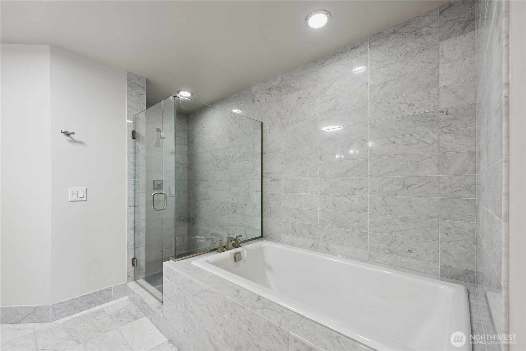 1920 4th Avenue, Unit 2702 Seattle, WA 98101 - Photo 22 of 40 a bathroom with a tub a sink and shower