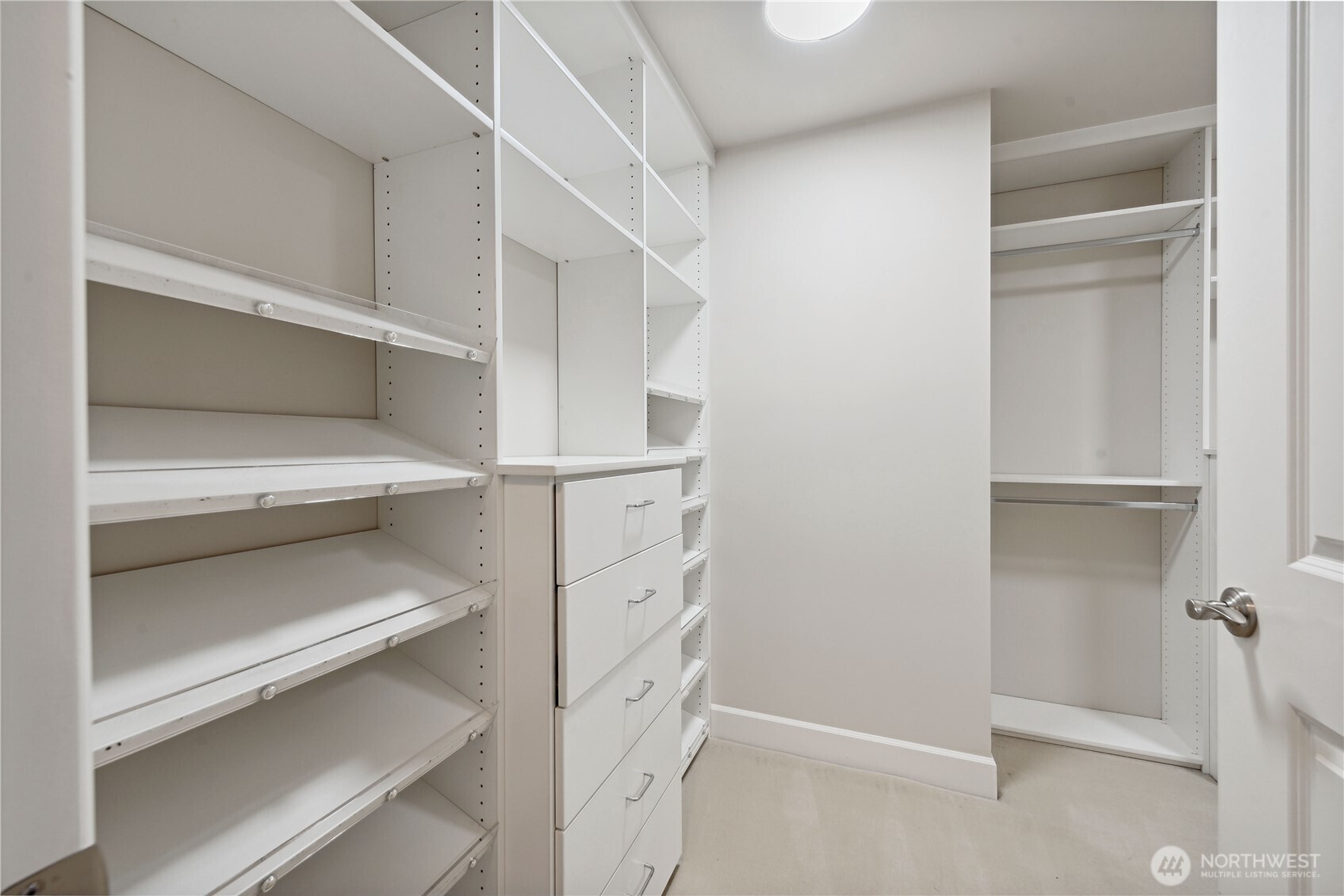 1920 4th Avenue, Unit 2702 Seattle, WA 98101 - Photo 23 of 40 a view of walk in closet with empty racks