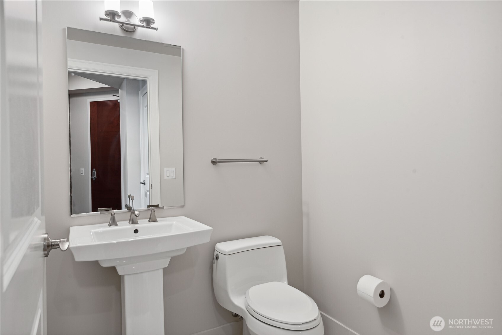 1920 4th Avenue, Unit 2702 Seattle, WA 98101 - Photo 27 of 40 a bathroom with a sink a toilet and mirror