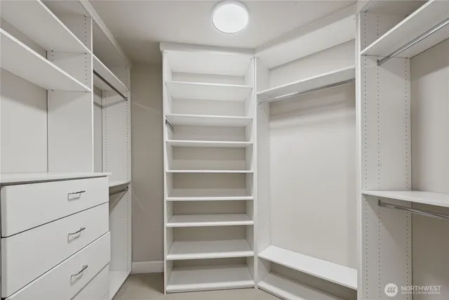 a view of walk in closet with empty racks