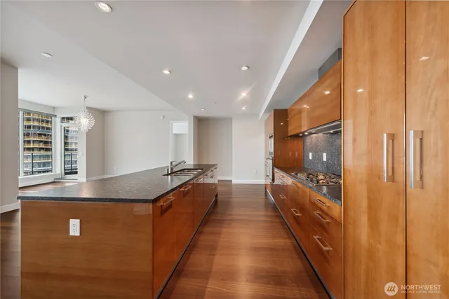 a large kitchen with kitchen island a large window