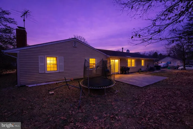 a backyard of a house with yard fire pit and outdoor seating