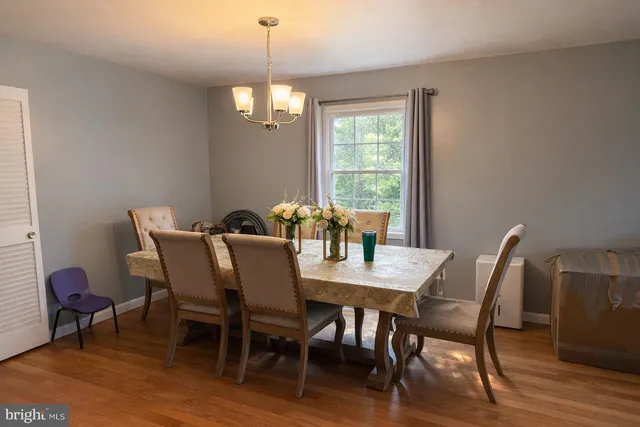 a kitchen with stainless steel appliances a refrigerator a sink and white cabinets