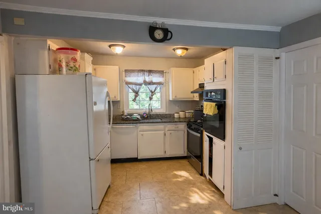 a view of a hallway with a dining room with furniture