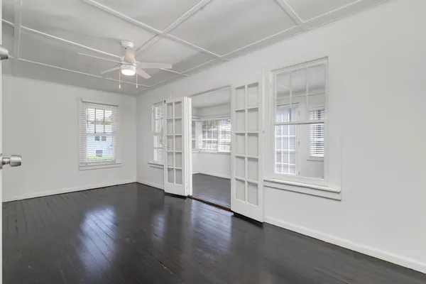 wooden floor in an empty room with a window