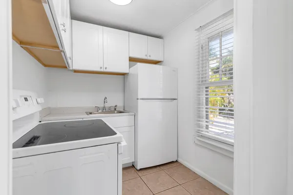 a kitchen with a sink and a refrigerator