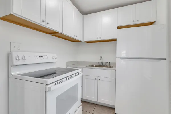 a kitchen with cabinets appliances and a sink