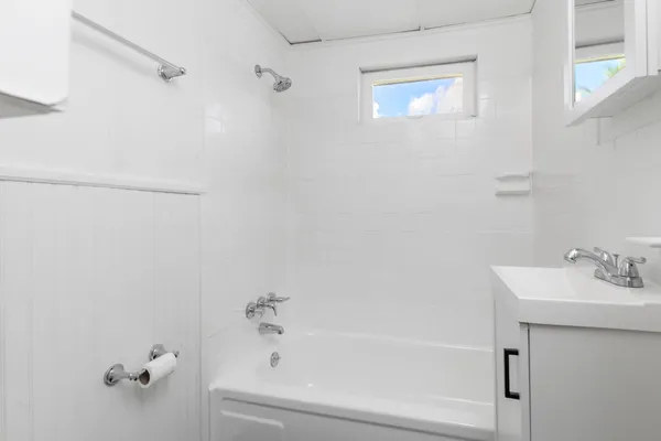 a bathroom with a bathtub and a sink