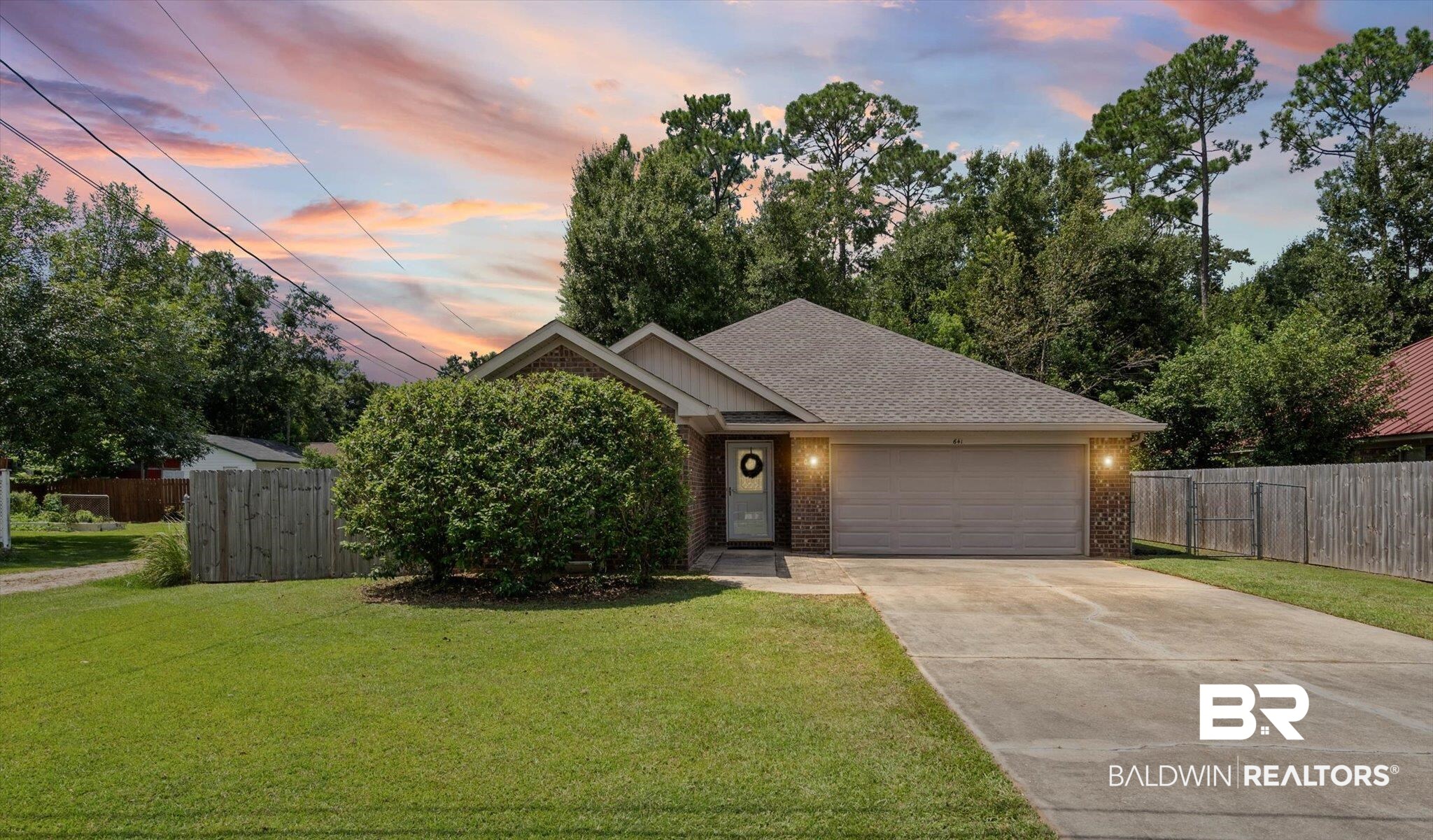 641 South Pine Street Foley, AL 36535 - Photo 1 of 22 View of front of home featuring brick siding, driveway, a shingled roof, and an attached garage