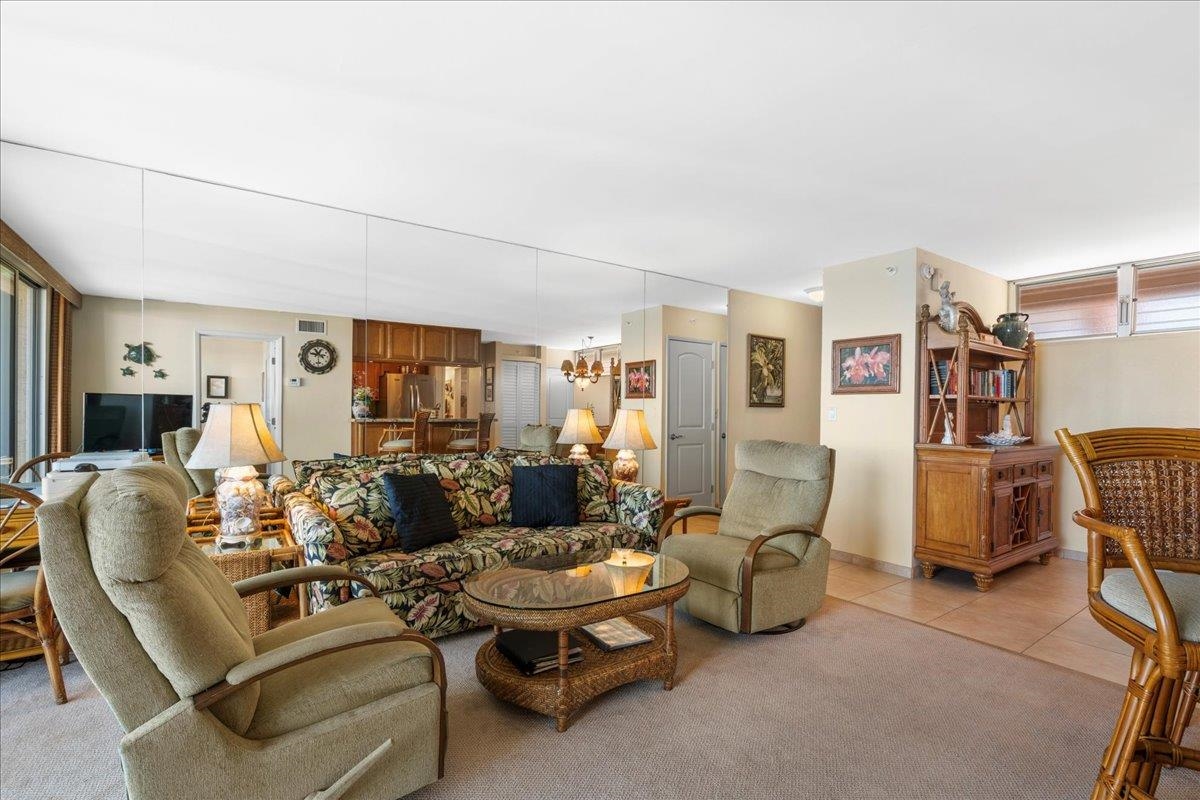 4365 Lower Honoapiilani Road, Unit 907 Lahaina, HI 96761 - Photo 12 of 23 a living room with furniture a flat screen tv and a table