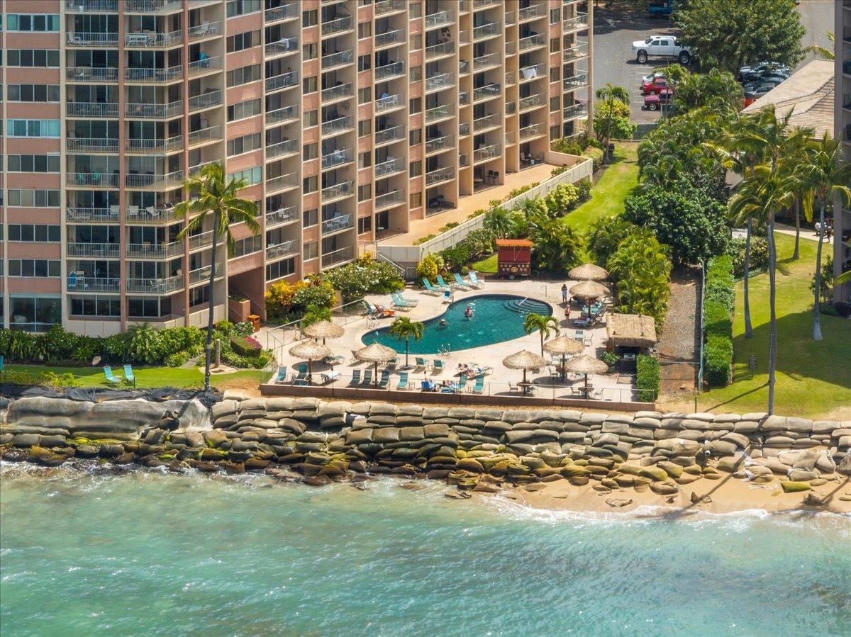 4365 Lower Honoapiilani Road, Unit 907 Lahaina, HI 96761 - Photo 21 of 23 a view of a pool with lawn chairs and plants
