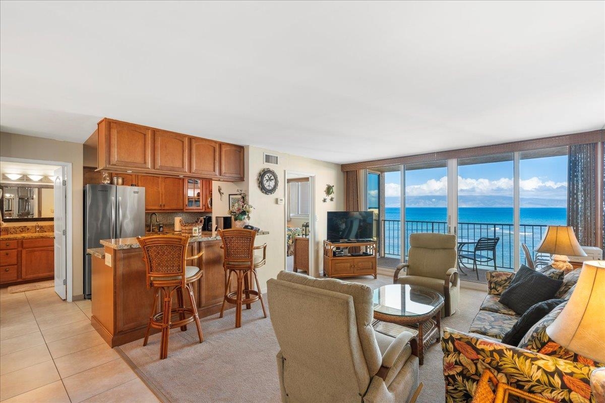 4365 Lower Honoapiilani Road, Unit 907 Lahaina, HI 96761 - Photo 7 of 23 a dining room with furniture and large windows