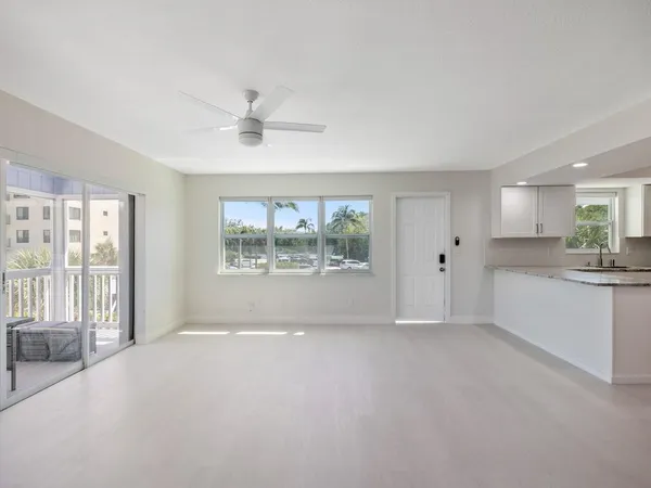a kitchen with stainless steel appliances white cabinets and a stove top oven