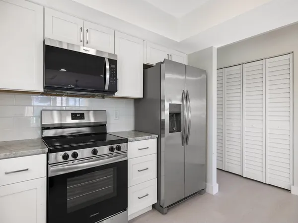 an empty room with a ceiling fan and a window