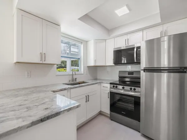 a view of a patio with table and chairs and potted plants